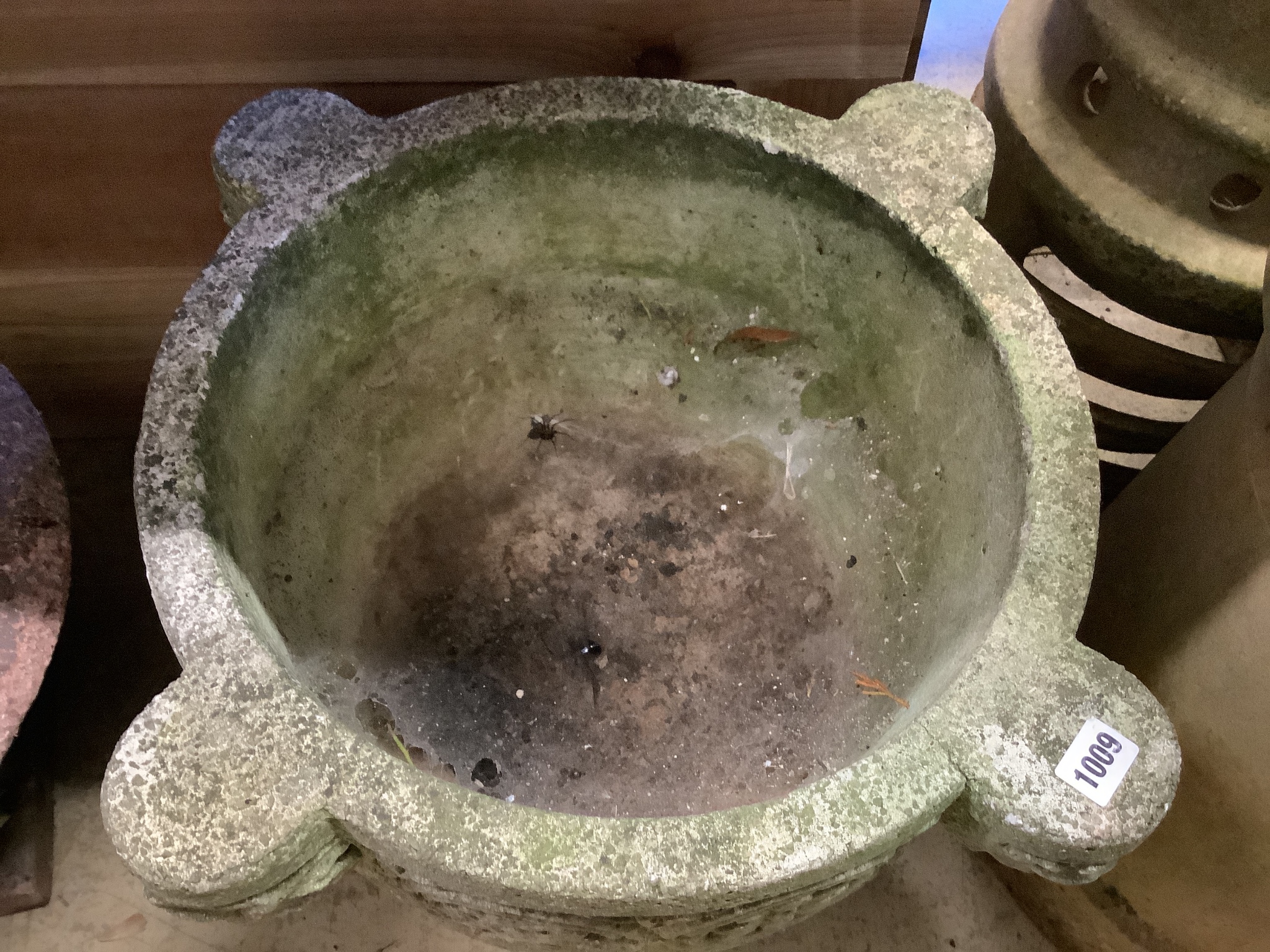 A reconstituted stone circular garden planter, diameter 55cm, height 36cm